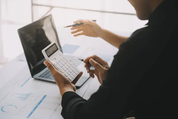 Finansal analistler, şirketlerin başarılı takım çalışmalarının sonuçlarını gösteren bir toplantıda bir dijital tablet planlama yatırım projesinin ticari mali raporlarını analiz ediyorlar..