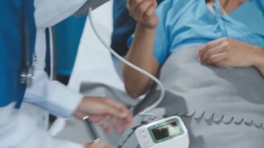 Doktor hastaların kan basıncını kontrol ediyor. Hastanedeki masada..