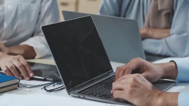 Ofiste dizüstü bilgisayar ve tablet bilgisayarla çalışan iş ekibi.