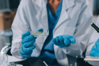 Laboratuvarda mikroskop kullanan bir bilim adamı. Laboratuvar ortamında modern bir mikroskobu ayarlayan bir araştırmacının ellerine yakın çekim. Bilim konsepti