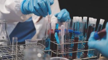 Laboratuvar asistanı laboratuarda bir test tüpü tutuyor..