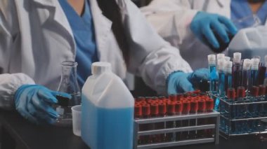 Tıbbi eldiven ve eldivenlerle laboratuvar testinde çalışan bir kadın doktoru kapatın..