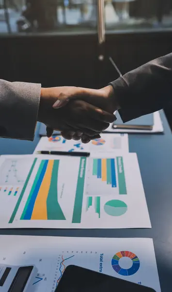 Handshake as successful negotiation ending, close-up. Unknown business people shaking hands after contract signing in modern office