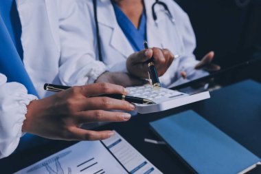 Dijital tablet sağlık doktoru teknolojisi tableti üzerinde çalışan tıbbi ekip hastanedeki tıbbi raporların sonuçlarını analiz etti..