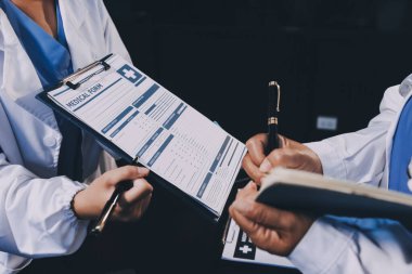 Dijital tablet sağlık doktoru teknolojisi tableti üzerinde çalışan tıbbi ekip hastanedeki tıbbi raporların sonuçlarını analiz etti..