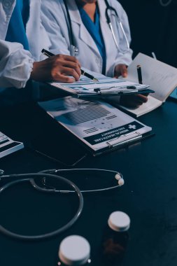 Dijital tablet sağlık doktoru teknolojisi tableti üzerinde çalışan tıbbi ekip hastanedeki tıbbi raporların sonuçlarını analiz etti..