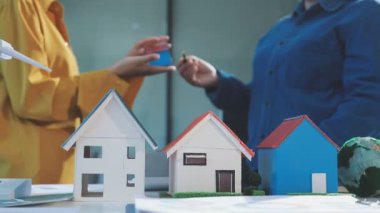Evin figürü bir model tutuyor..