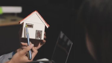 man holding house model in hands