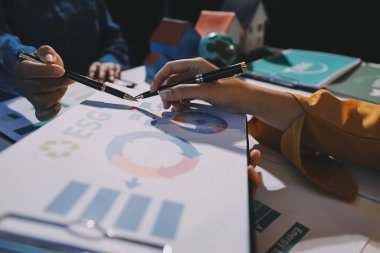 ESG 'nin çevresel sosyal yönetimi, çevre dostu şirket toplantılarında, temiz ve sürdürülebilir gelecekteki ekoloji için çevre korumasını uygulayan iş adamlarıyla dizüstü bilgisayarda sergileniyor. Önde.