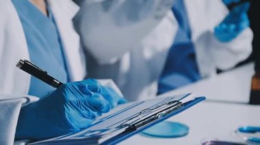 Kadın doktor elinde şırınga tutuyor.