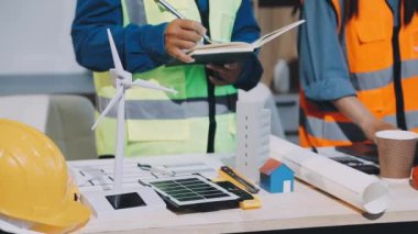 Masada dizüstü bilgisayar ve tablet bilgisayarla çalışan mühendis.