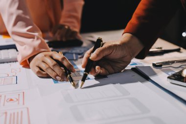 Genç Asyalı iş dünyası yaratıcı takımı mobil uygulama yazılım tasarımı projesinde birlikte çalışıyor. Beyin fırtınası toplantısı, internet teknolojisi, akıllı telefon uygulama tasarımcısı, ofis çalışanı takım çalışması konsepti