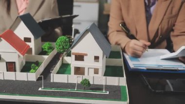 Emlakçı müşterinin modeliyle evi tartışıyor ya da satın alıyor.
