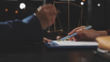 Avukat, belgeler ve müvekkil ile birlikte çalışıyor.
