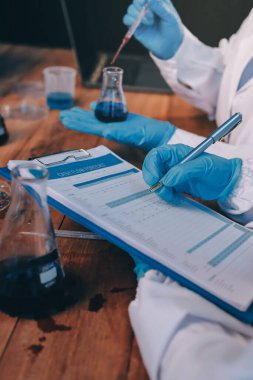 Laboratuvarda kan testi. Dispanser ile çalışan laboratuvar asistanı. Kanlı vakum tüpleri..