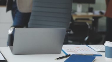 businessman in office with laptop and documents