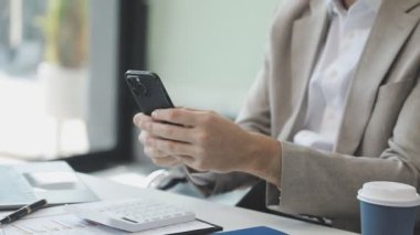 Genç işadamı, modern bir iş yerinde dizüstü bilgisayarla çalışıyor.