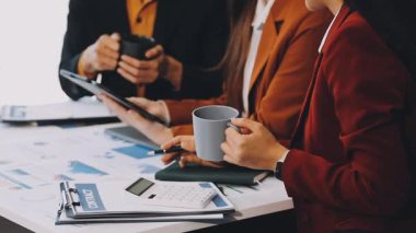 İş yerindeki iş adamları iş yerindeki mali tabloları tartışıyor.