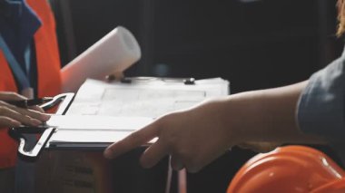 İnşaat işçisi, zemini mezurayla ölçmek için dizüstü bilgisayar kullanıyor.