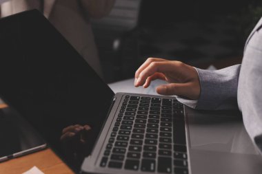 Group of confident business people point to graphs and charts to analyze market data, balance sheet, account, net profit to plan new sales strategies to increase production capacity.
