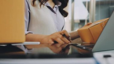 Ofiste dizüstü bilgisayar kullanan genç bir kadın.