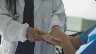 Kadın doktor beyaz bir arkaplanda hasta elini tutuyor. tıbbi personel