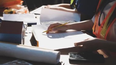 Arka planda inşaat araçlarıyla çalışan mühendis veya mühendis.