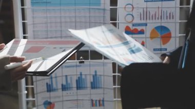 İş kadını, bürodaki belgelerde mali tabloları analiz ediyor..