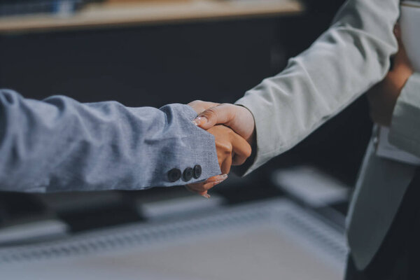 Business handshake for teamwork of business merger and acquisition,successful negotiate,hand shake,two businessman shake hand with partner to celebration partnership and business deal concept
