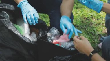 Kadın çöp torbasına çöp atıyor, çevre kirliliği kavramı