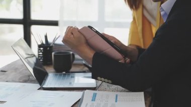 Ofiste tableti ve bilgisayarı olan bir işadamı var.