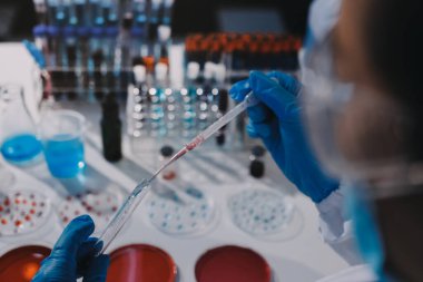 Profesyonel mikroskop kullanan bir araştırmacı.