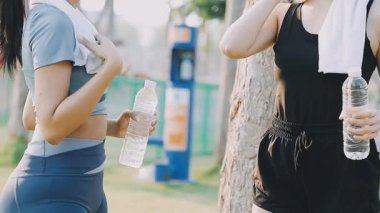 Sabah parkında koştuktan sonra su içen kadın
