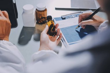 Erkek ve kadın doktorlar bir hastane odasında toplantı yapıyorlar..