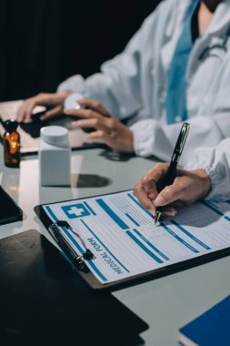 Erkek ve kadın doktorlar bir hastane odasında toplantı yapıyorlar..