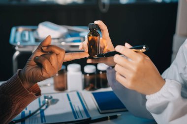 Uzman doktor bir hastaya ilaç götürmeyi açıklıyor. Sağlık ve İlaç danışmanlığı.