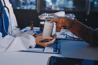 Uzman doktor bir hastaya ilaç götürmeyi açıklıyor. Sağlık ve İlaç danışmanlığı.