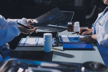 Erkek ve kadın doktorlar bir hastane odasında toplantı yapıyorlar..