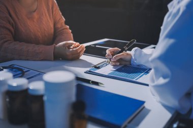 Uzman doktor bir hastaya ilaç götürmeyi açıklıyor. Sağlık ve İlaç danışmanlığı.