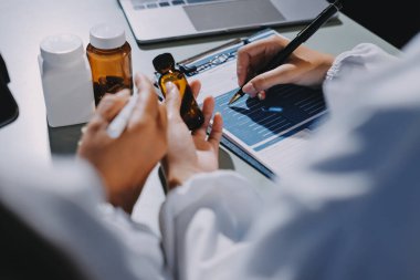 Erkek ve kadın doktorlar bir hastane odasında toplantı yapıyorlar..