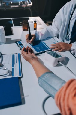 Hemşire masada yaşlı kadının kan basıncını ölçtü, yakın çekim. Üst düzey nesillere yardımcı olmak