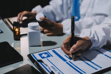 Erkek ve kadın doktorlar bir hastane odasında toplantı yapıyorlar..