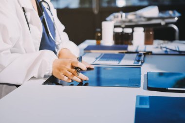 Doktor, emekliye ayrılmış yaşlı kadına akciğer röntgeni çeken hastanın sağlık ve hayat sigortası planlarını kullanarak hastane bakım evindeki hastalara tedavi yöntemlerini anlattı.