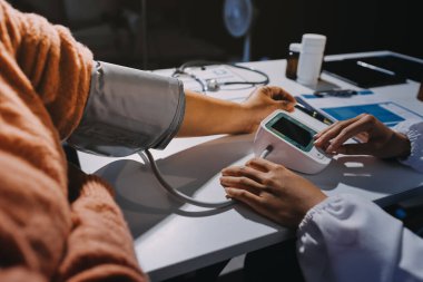 Hemşire masada yaşlı kadının kan basıncını ölçtü, yakın çekim. Üst düzey nesillere yardımcı olmak