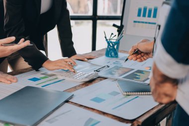 Muhasebe şirketi kazançlı nakit akışı için finansman ve vergilendirme planlaması, ofiste çalışan denetçi ve muhasebeci ekibi, mali verileri ve muhasebe kayıtlarını hesap makinesiyle analiz eder.