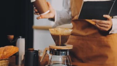 Kahve bardağına kahve dolduran, kafede kahve yapan, kapatan.