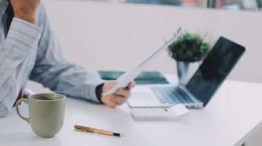 İş adamı evde dizüstü bilgisayar ve cep telefonuyla çalışıyor.