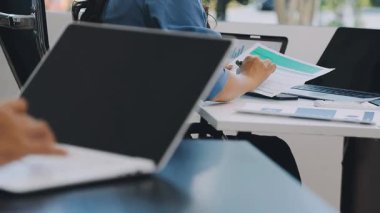 İş adamları ofiste tartışıyor ve çalışıyor.