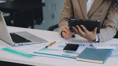 Hesap makinesi ve dizüstü bilgisayarı olan genç bir iş adamı