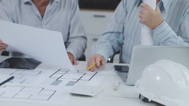 Mimar ve mimarlar ofiste çalışıyorlar.